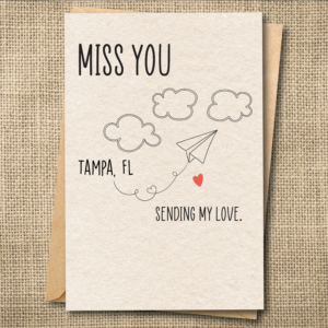 Personalized miss you card showing New Tampa, FL as location with paper airplane design